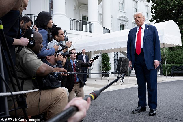 US President Donald Trump stops to speak with reporters while walking to Marine One on the South Lawn of the White House September 21, 2025, in Washington, DC. Trump is heading to Glendale, Arizona to attend the public memorial service for Charlie Kirk. (Photo by Brendan Smialowski / AFP) (Photo by BRENDAN SMIALOWSKI/AFP via Getty Images)