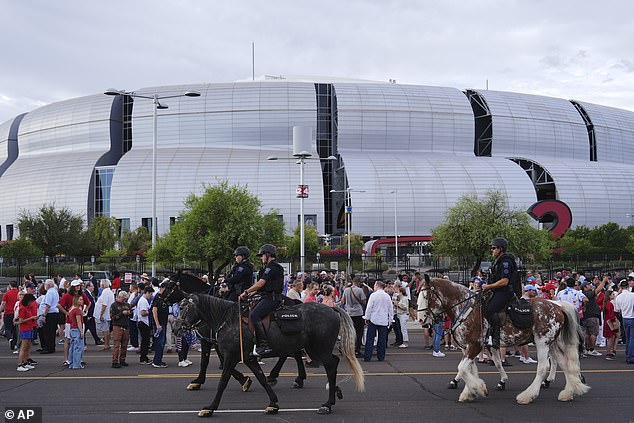 Police ride around on horses outside before a memorial for conservative activist Charlie Kirk, Sunday, Sept. 21, 2025, at State Farm Stadium in Glendale, Ariz. (AP Photo/Jae C. Hong)