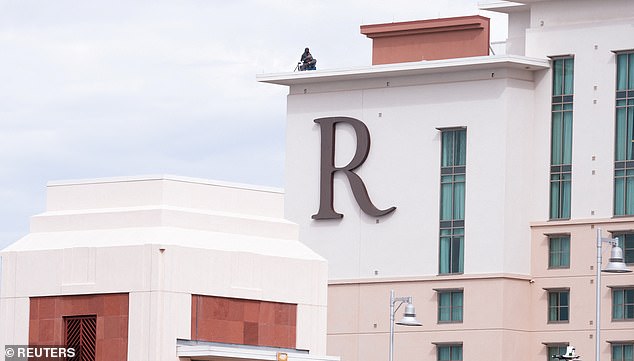 Security personnel keep a lookout from a roof, on the day of a memorial service for slain conservative commentator Charlie Kirk in State Farm Stadium, in Glendale, Arizona, U.S., September 21, 2025.Â  REUTERS/Cheney Orr