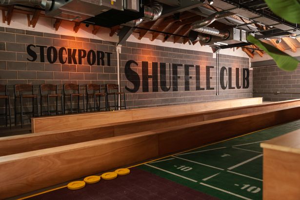 The new social club features deck shuffleboard and table shuffleboard 