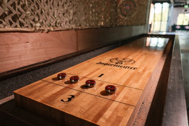 The venue features two types of shuffleboard 