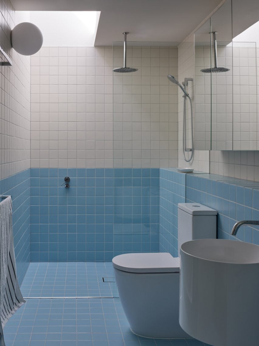 Tiled bathroom lit by skylight