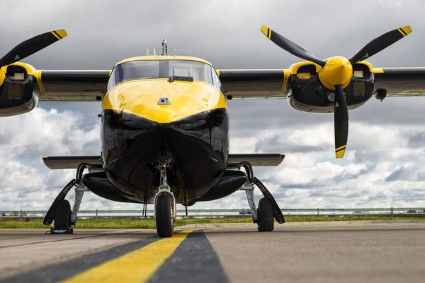 A picture of the yellow and black tiny plane on the runway