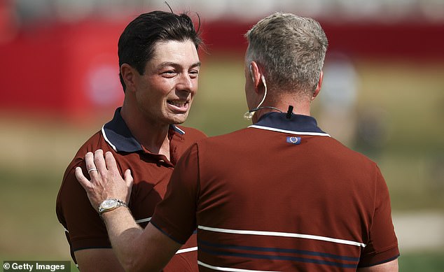 FARMINGDALE, NEW YORK - SEPTEMBER 27: Viktor Hovland of Team Europe talks with captain Luke Donald after Hovland and Robert MacIntyre of Team Europe defeated Scottie Scheffler and Russell Henley of Team United States 1UP during the Saturday morning foursomes matches of the 2025 Ryder Cup at Black Course at Bethpage State Park Golf Course on September 27, 2025 in Farmingdale, New York. (Photo by Jared C. Tilton/Getty Images)