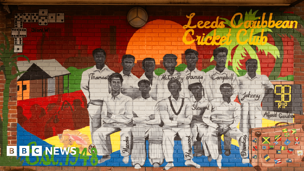 A brightly painted mural, depicting a cricket team against the backdrop of a sun and a palm tree. The flags of Caribbean nations are in the corner. The mural is marked 'Leeds Caribbean Cricket Club est. 1948'
