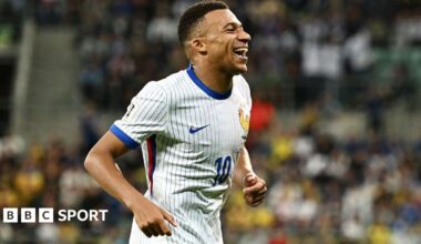 Kylian Mbappe smiles widely after scoring for France against Ukraine