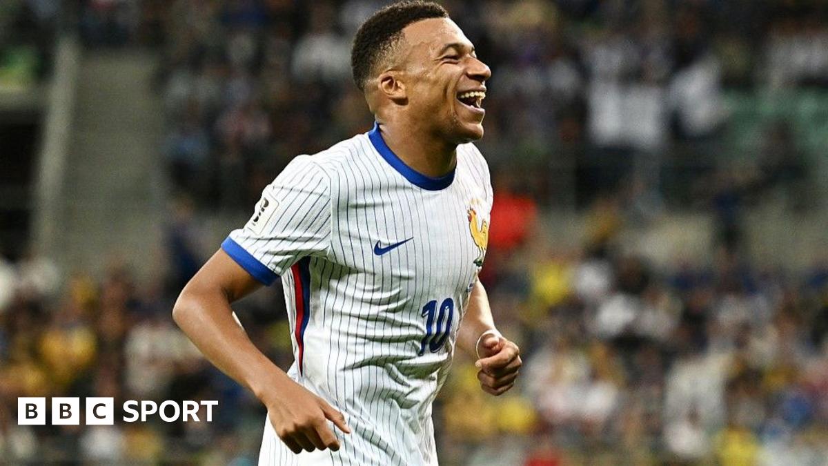 Kylian Mbappe smiles widely after scoring for France against Ukraine