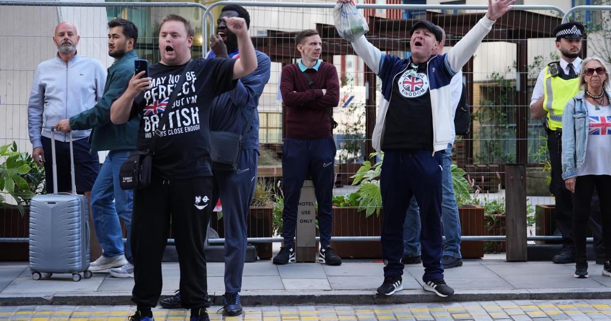 Police officer punched in face at anti-asylum protest in London