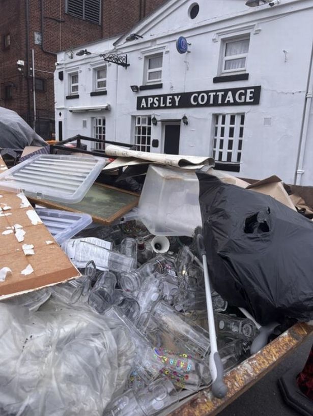 A skip piled high with materials from inside the Apsley Cottage pub.