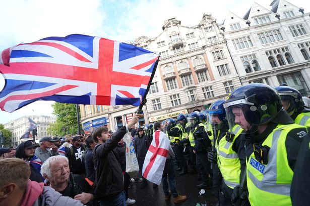 People taking part in a Tommy Robinson-led Unite the Kingdom march and rally in central London.