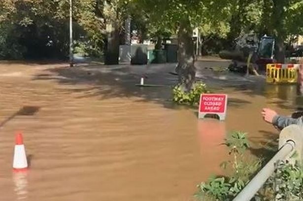 The residential road in Trafford turned into a deluge with emergency crews called out