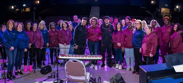 Festival director Anu Omideyi centre with Luiz Diaz (R) and Alex Oxlade-Chamberlain (L) with the Love & Joy Gospel Choir at Liverpool Lighthouse in Anfield (Image: Brian Roberts)