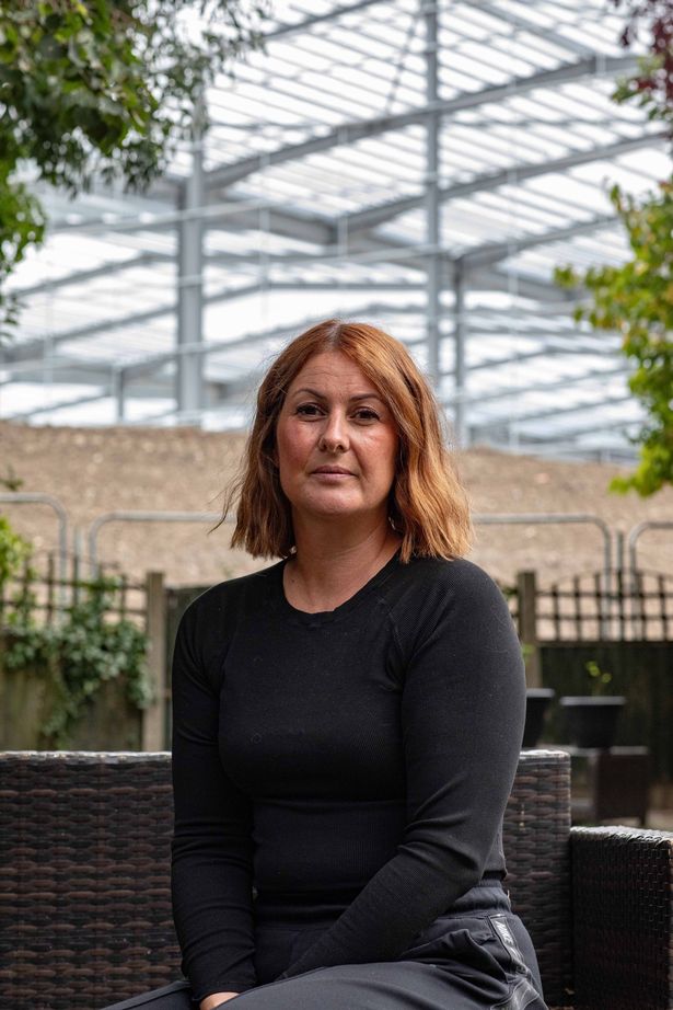 Paula Boardman, 47, lives with her husband and two kids in a house that backs onto the imposing warehouse