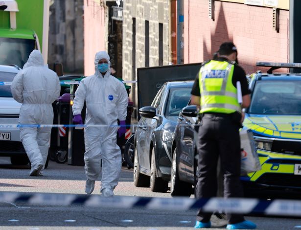 Forensic officers within the cordon in Edinburgh.