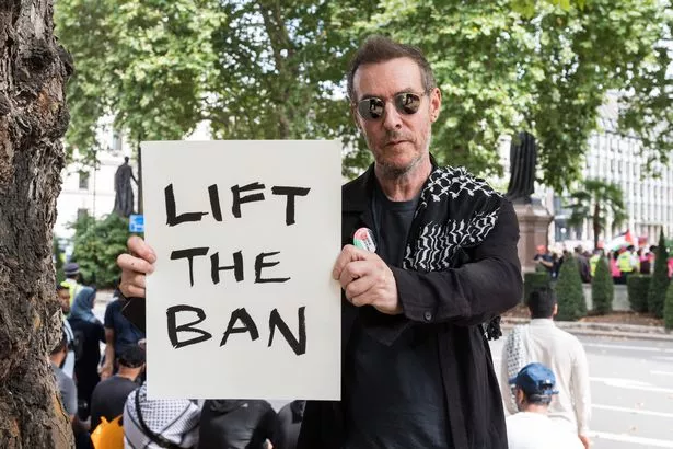 Robert Del Naja, also known as 3D, of Massive Attack holds a placard reading 'Lift the Ban' as hundreds of people gather to take part in a mass demonstration in Parliament Square against the ban on Palestine Action in London, United Kingdom on September 06, 2025. 