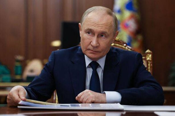 image of Putin sat at a desk 