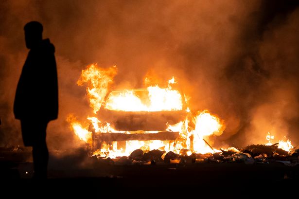 Cars were set alight on the streets during the Ely riots as police faced off with protesters