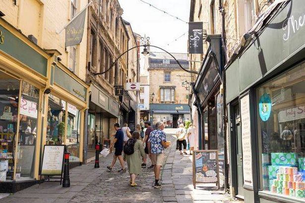 View of shops and visitors Stone Street in Frome