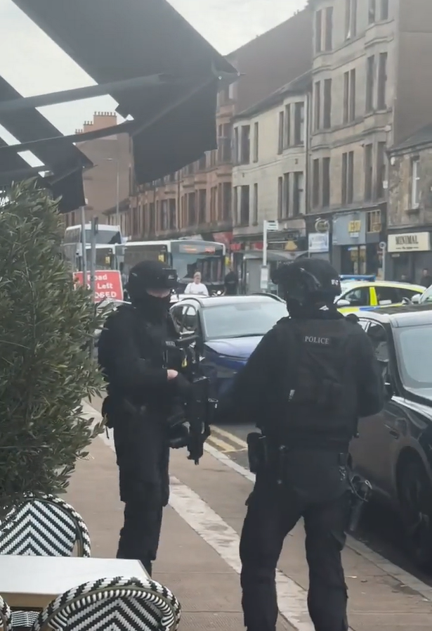 Café customers left shocked as armed police seal off busy street