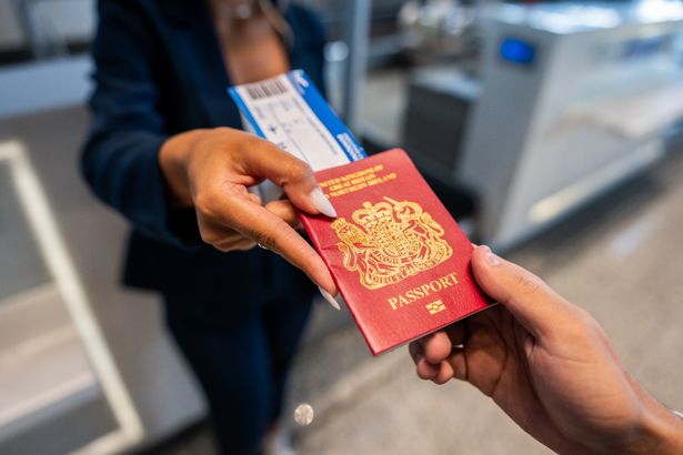 Close-up of giving passport to an airline attendant at the airport