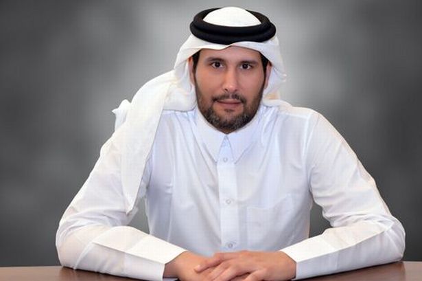 Sheikh Jassim sitting at a table