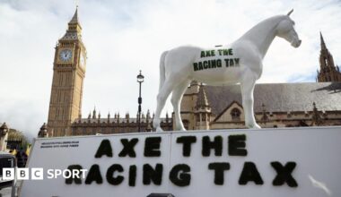 A statue of a horse with the 'Axe The Racing Tax' was part of a protest against the government's proposed tax rise on betting on horse racing