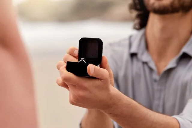 Getty Stock image of man kneeling to propose.