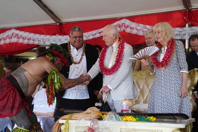 The King thanks a person who presented him and the Queen with a gift during a farewell ceremony at Siumu Village on the final day of the royal visit to Australia and Samoa in October 2024