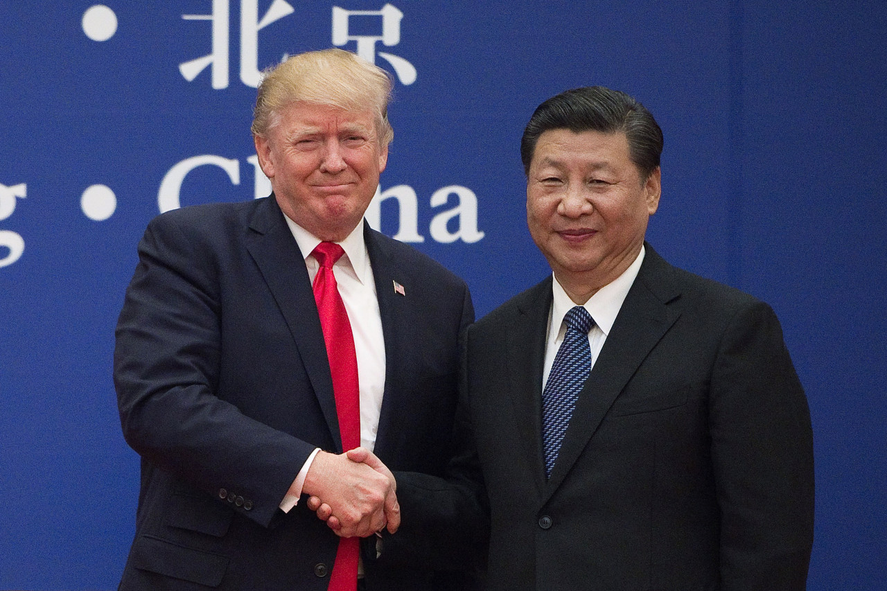 In this file photo taken on Nov.8, 2017, United States President Donald Trump (left) and China's President Xi Jinping shake hands during a business event at the Great Hall of the People in Beijing.