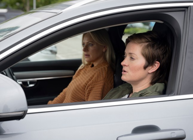 Becky and Lisa sat in the front seats of a car in Corrie