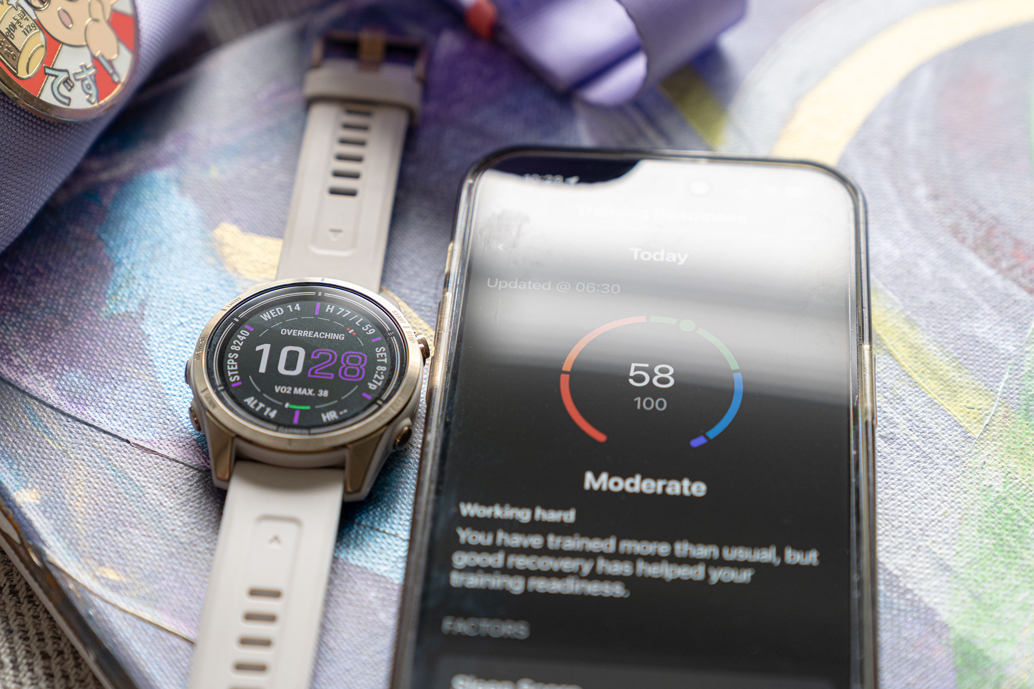 Garmin Epix Pro next to iPhone showing Garmin Connect app