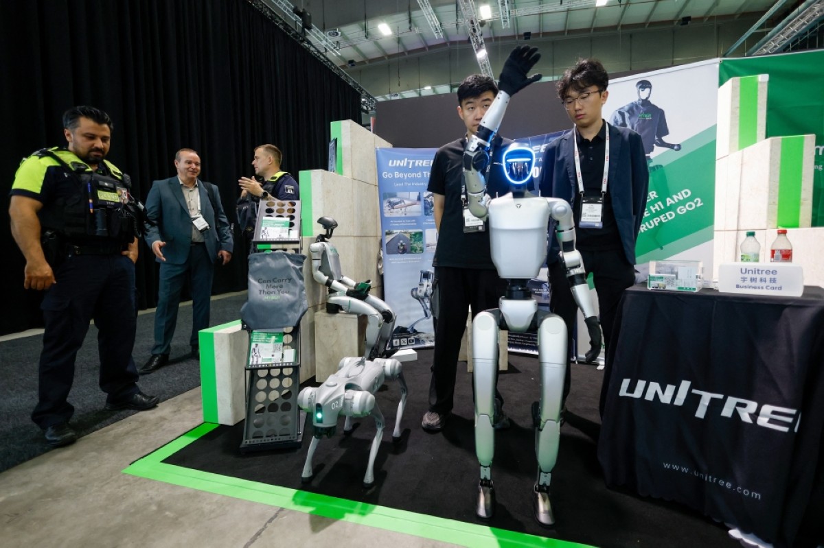 BERLIN: Police officers (left) are seen at the stand of Chinese robotics company Unitress robotics at the IFA international trade show for consumer electronics and home appliances, on September 5, 2025 in Berlin. -- AFP