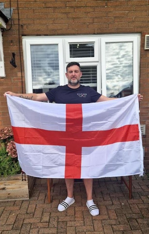 Kevin Houten outside his home with his England flag