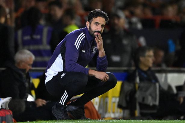 Ruben Amorim crouches down and looks on