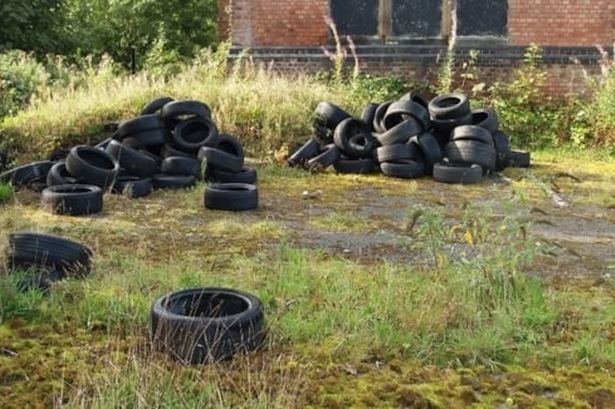 The tyres were dumped on the land of a former pub in south Manchester