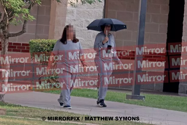 Maxwell walking with another inmate