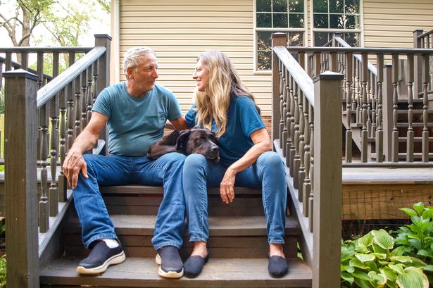 Senior couple on steps with dog