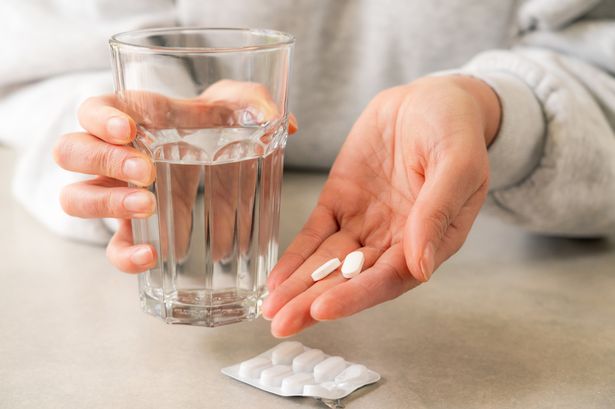 Person taking a painkiller pill
