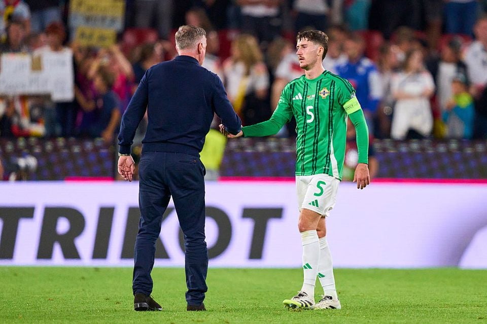 Trai Hume shakes hands with Northern Ireland boss Michael O'Neill after the defeat to Germany