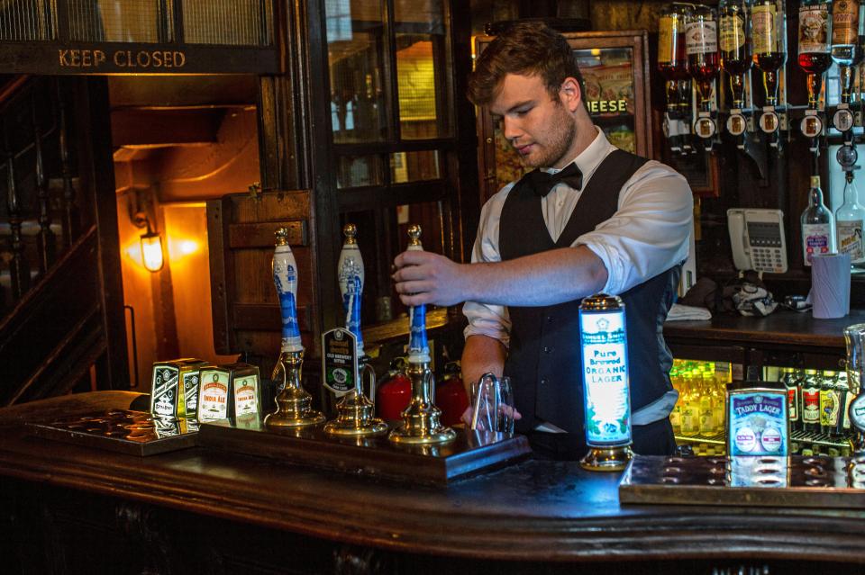 Bartender pouring beer at a pub.