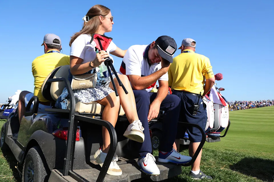 Scottie Scheffler is consoled by his wife, Meredith, after he and Brooks Koepka lost their match to Viktor Hovland and Ludvig Aberg of Team Europe 9 and 7 during the Saturday morning foursomes matches of the 2023 Ryder Cup at Marco Simone Golf Club.