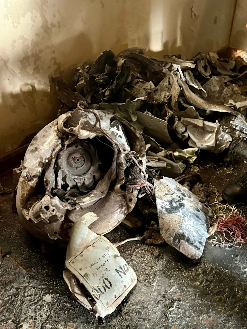 Wreckage of a turbojet for a cruise missile is seen in a structurally intact room.