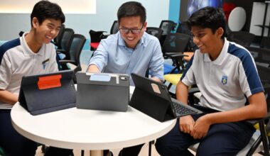 Mr Neo Guang Xian (centre) with Secondary 3 students William Teh (left) and Jain Arnav at a computing lesson at Ngee Ann Secondary School.