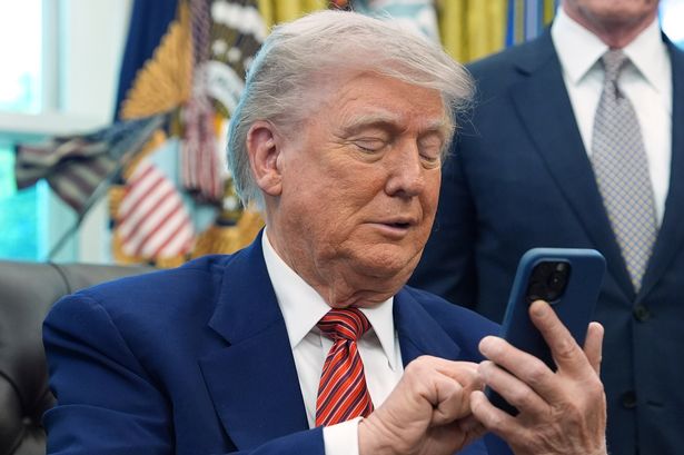 Donald Trump using a mobile phone