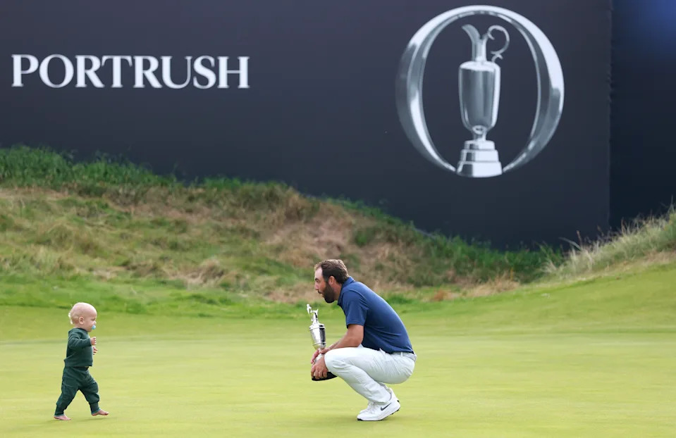 Scottie Scheffler of the United States celebrates with his son Bennett Scheffler and the Claret Jug on the 18th green after winning The 153rd Open Championship at Royal Portrush Golf Club on July 20, 2025 in Portrush, Northern Ireland.