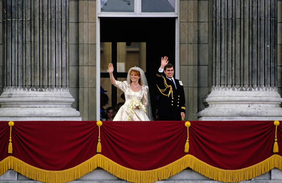 Sarah Ferguson and Prince Andrew waving from the Buckingham Palace balcony on their wedding day
