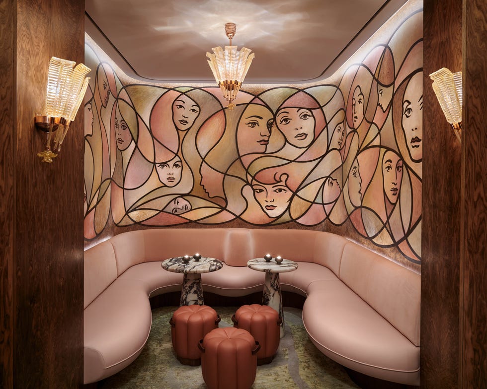 A stylish seating area with a unique wall mural and modern furnishings.