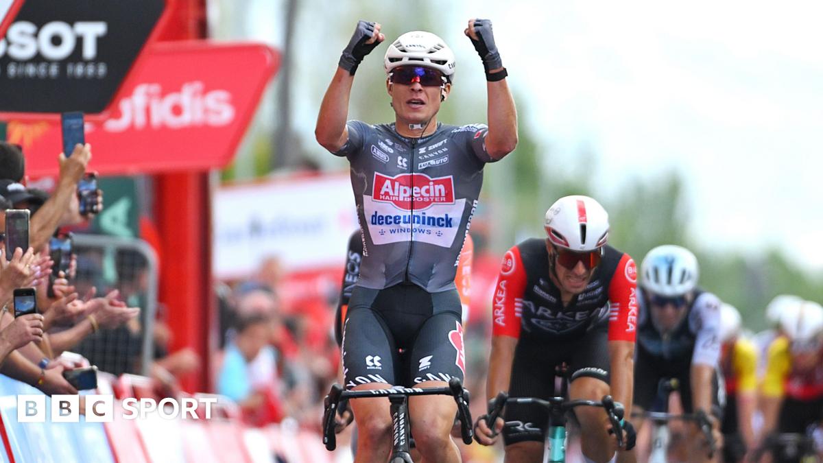 Jasper Philipsen raises his fists in celebration