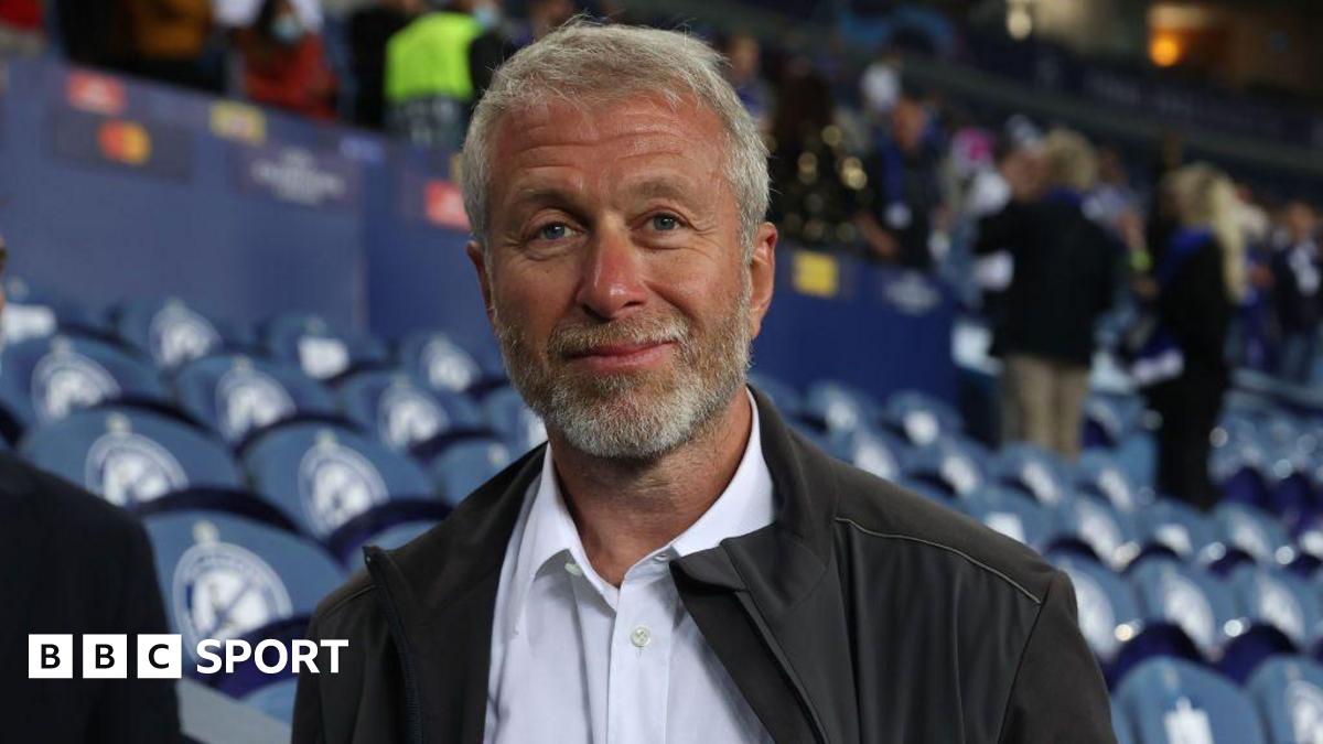 Roman Abramovich wearing a white shirt and black jacket