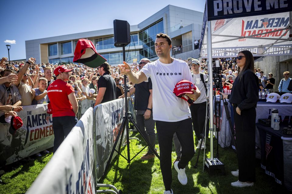Charlie Kirk hands out hats before speaking at Utah Valley University (Tess Crowley/The Deseret News via AP)